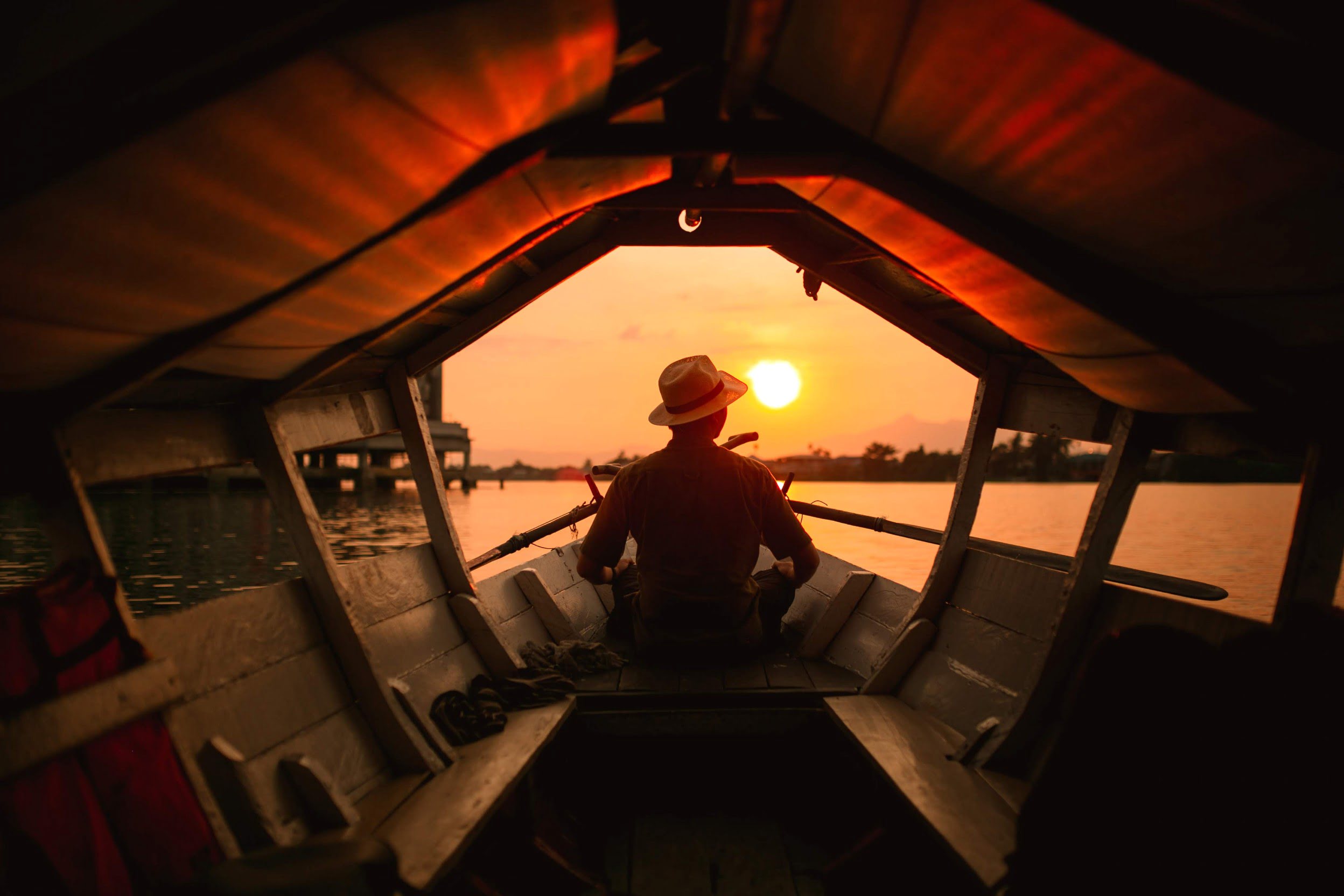 A boat moves through the still water channels of the Okavango Delta, Botswana.