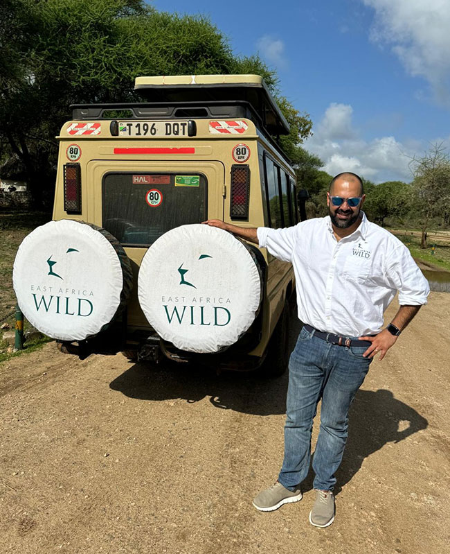 Ryan Elliott standing next to a Safari vehicle